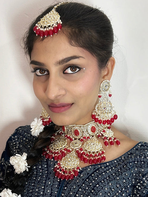 Crimson Red Kundan Necklace, Earrings & Maang Tikka Set from Trenzify Store.