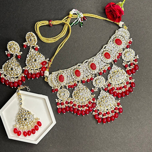 Crimson Red Kundan Necklace, Earrings & Maang Tikka Set from Trenzify Store.