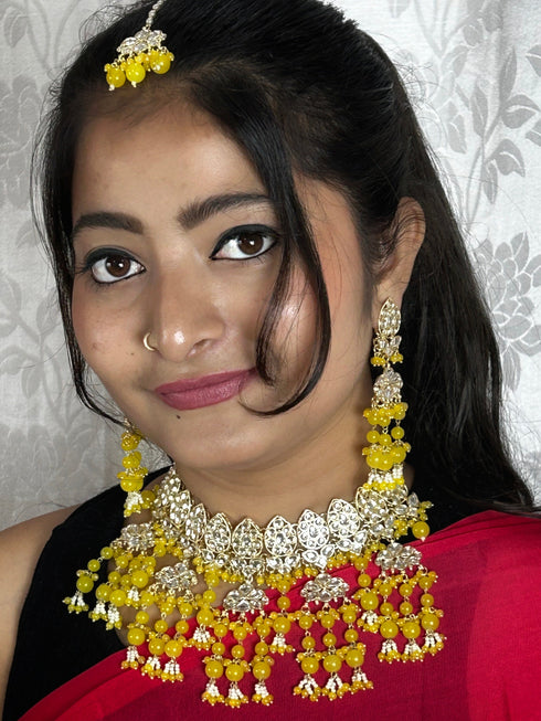 Yellow Kundan Necklace, Earrings & Maang Tikka Set from Trenzify Store.