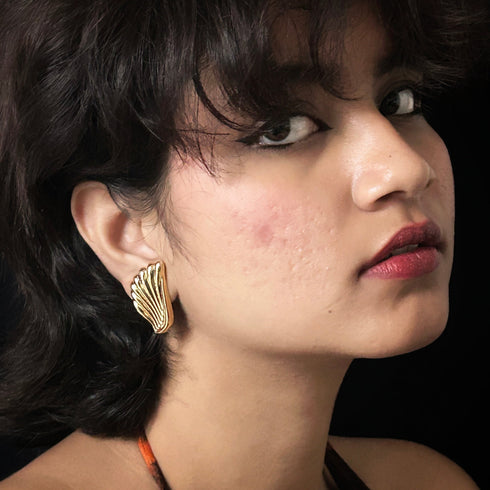 Golden wing-shaped anti-tarnish earrings with feather texture, elegant jewelry for women from Trenzify Store.