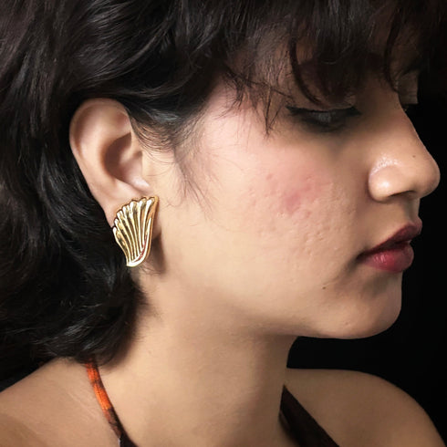 Golden wing-shaped anti-tarnish earrings with feather texture, elegant jewelry for women from Trenzify Store.