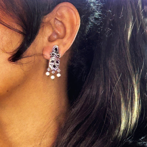 Silver earrings adorned with blue gemstones and pearls, creating a classic, timeless design. From Trenzify Store.