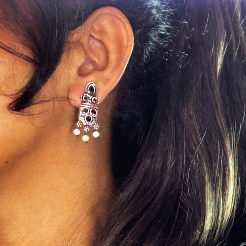 Silver earrings with black gemstones and pearls, offering a chic and sophisticated design. From Trenzify Store.