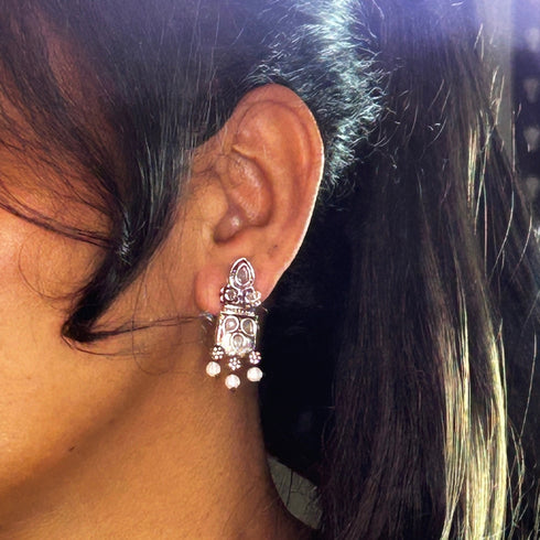 Silver earrings with intricate gemstone detailing, featuring pearl accents and a traditional design. From Trenzify Store.