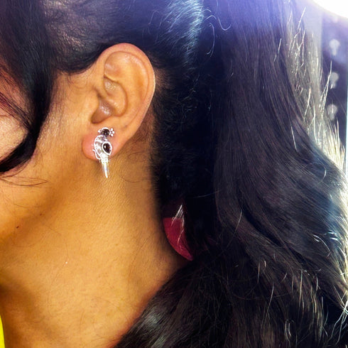 Silver peacock-shaped earrings with striking black and clear gemstones, featuring a sleek, modern bird design. From Trenzify Store.