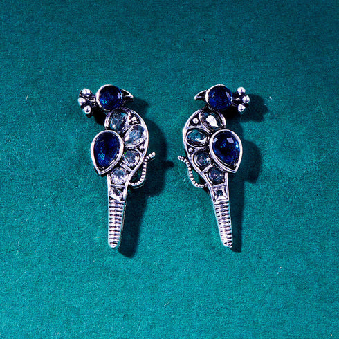 Silver peacock-shaped earrings with blue and clear gemstones, capturing the beauty of a bird design with a pop of vibrant blue. From Trenzify Store.