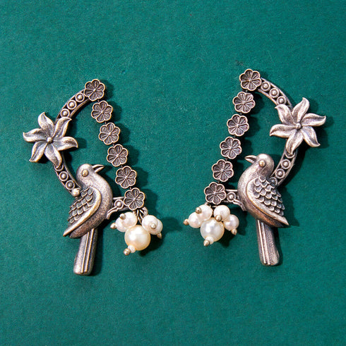 Antique Silver Twin Peacock Jhumka Earrings with Pearl Drops from Trenzify Store.