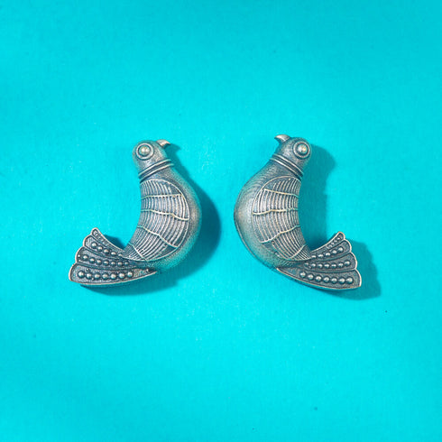 Handcrafted oxidized silver bird-shaped earrings with intricate detailing and antique finish, perfect for adding a unique touch to ethnic or boho outfits. Trenzify Store