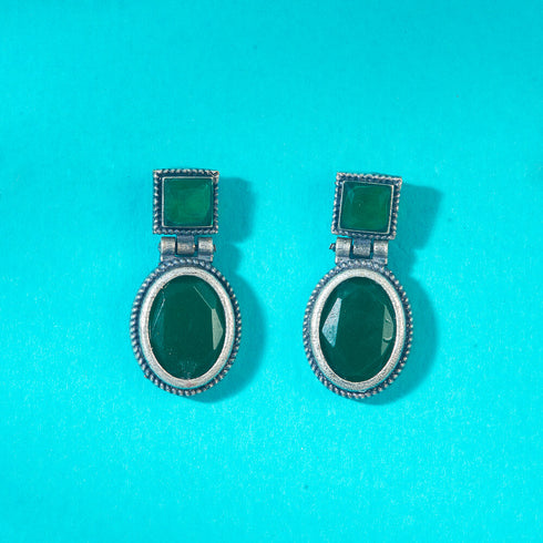 Statement earrings featuring rich green gemstones in a dual-shape design, square top and oval drop, encased in antique silver finish. Trenzify Store