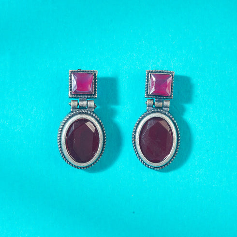 Vintage-style dangle earrings with deep ruby red square and oval gemstones set in oxidized silver. Elegant and timeless design for evening wear. Trenzify Store