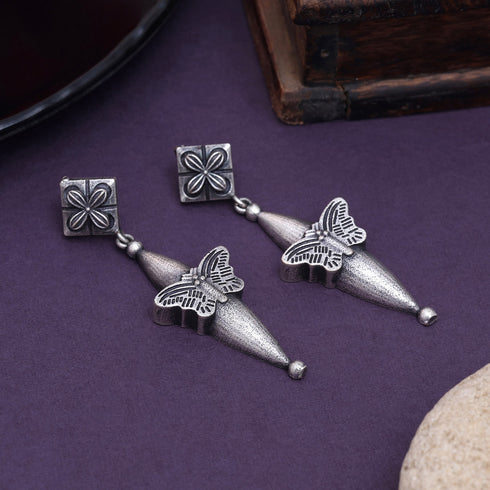 Handcrafted oxidized earrings with butterfly motif, cone-shaped drop, and floral stud top – ethnic silver jewelry - Trenzify Store