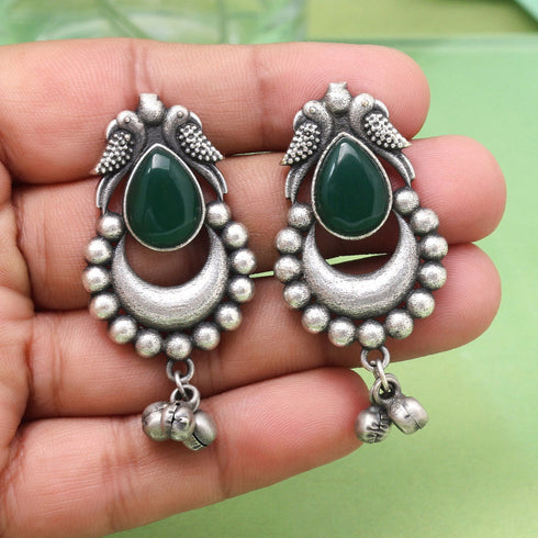Oxidized earrings with green stone, bird motif, crescent design, and hanging ghungroo bells – ethnic statement jewelry