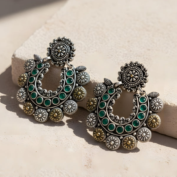 Handcrafted oxidized crescent chandbali earrings with green stone inlay, intricate floral motifs and antique silver finish in ethnic statement design from Trenzify Store
