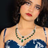 Model wearing American Diamond (CZ) green stone necklace set with matching earrings – imitation jewelry from Trenzify Store.