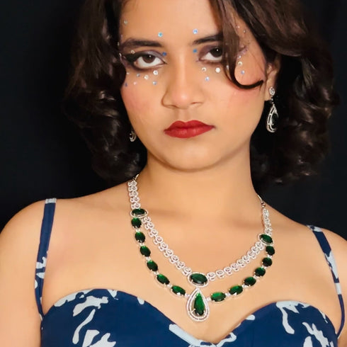Model wearing American Diamond (CZ) green stone necklace set with matching earrings – imitation jewelry from Trenzify Store.