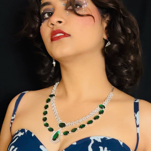 Model wearing American Diamond (CZ) green stone necklace set with matching earrings – imitation jewelry from Trenzify Store.