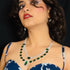 Model wearing American Diamond (CZ) green stone necklace set with matching earrings – imitation jewelry from Trenzify Store.