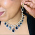 Model wearing American Diamond (CZ) blue teardrop necklace set with matching earrings – imitation jewelry from Trenzify Store.