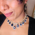 Model wearing American Diamond (CZ) blue teardrop necklace set with matching earrings – imitation jewelry from Trenzify Store.