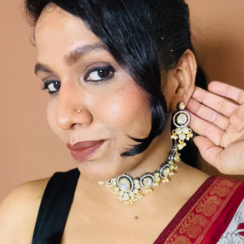 Model wearing black rhodium and gold plated Kundan choker necklace set with matching earrings – imitation jewelry from Trenzify Store.