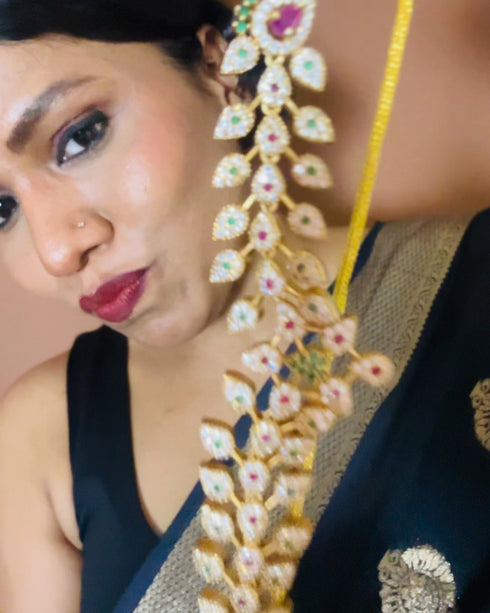 Model wearing American Diamond CZ necklace set with pink stones, green accents and gold plating – elegant floral jewelry with matching earrings, perfect for weddings and parties.