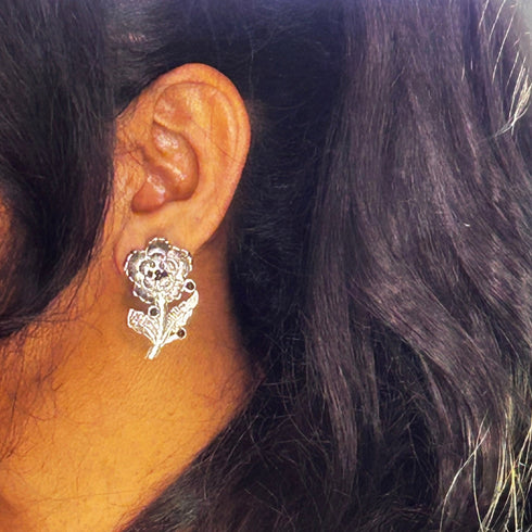 Vintage-style floral earrings with black bead accents on silver-tone metal. From Trenzify Store.