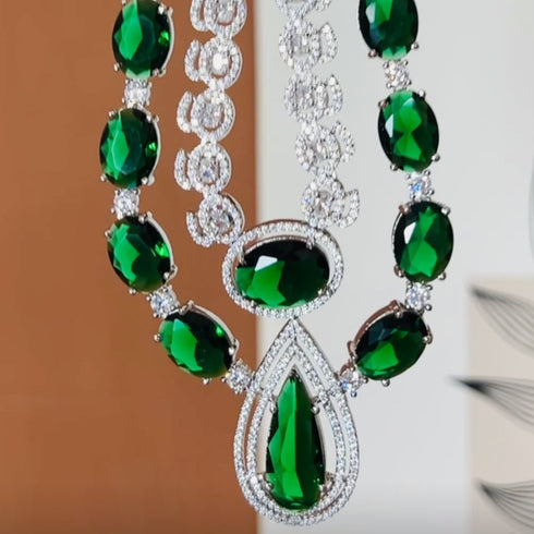 Model wearing American Diamond (CZ) green stone necklace set with matching earrings – imitation jewelry from Trenzify Store.