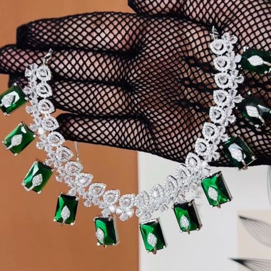 Model wearing American Diamond (CZ) green rectangular stone necklace set with matching earrings – imitation jewelry from Trenzify Store.