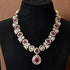 Elegant ruby red stone necklace set with matching drop earrings, featuring teardrop design, white CZ embellishments, and gold-plated finish – perfect for weddings and festive occasions.