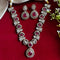 Elegant ruby red stone necklace set with matching drop earrings, featuring teardrop design, white CZ embellishments, and gold-plated finish – perfect for weddings and festive occasions.