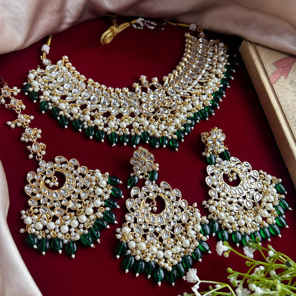 Traditional Kundan bridal necklace set with green bead detailing, gold plating, and matching chandbali earrings and Maang Tikka from Trenzify Store.