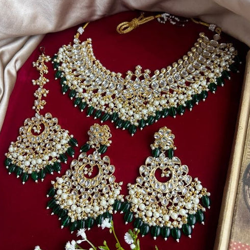 Traditional Kundan bridal necklace set with green bead detailing, gold plating, and matching chandbali earrings and Maang Tikka from Trenzify Store.