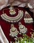 Complete kundan bridal jewelry set featuring necklace, earrings, maang tikka and passa with red beads and pearls - Trenzify Store