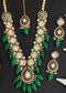 Gold plated Kundan necklace set with green stones, red enamel accents, pearls and matching earrings and maang tikka – traditional bridal jewelry from Trenzify Store.