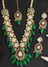 Gold plated Kundan necklace set with green stones, red enamel accents, pearls and matching earrings and maang tikka – traditional bridal jewelry from Trenzify Store.